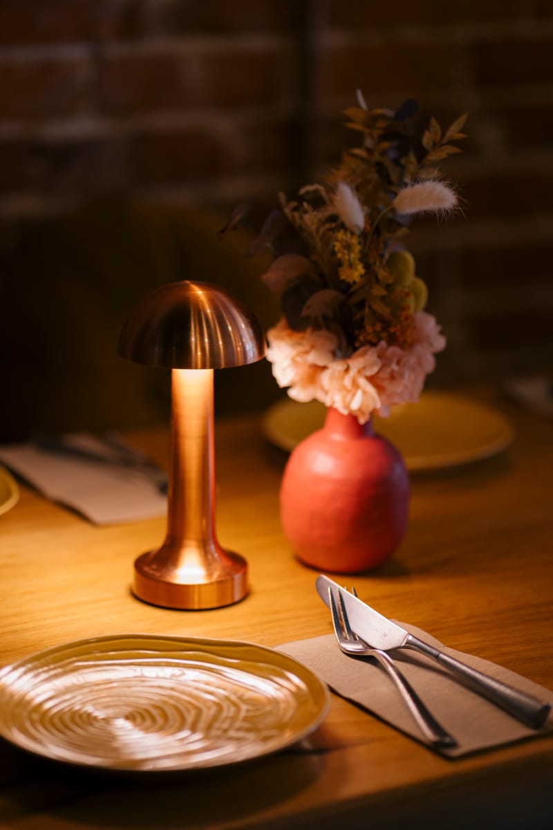 Copper lamp and dried flowers on the table